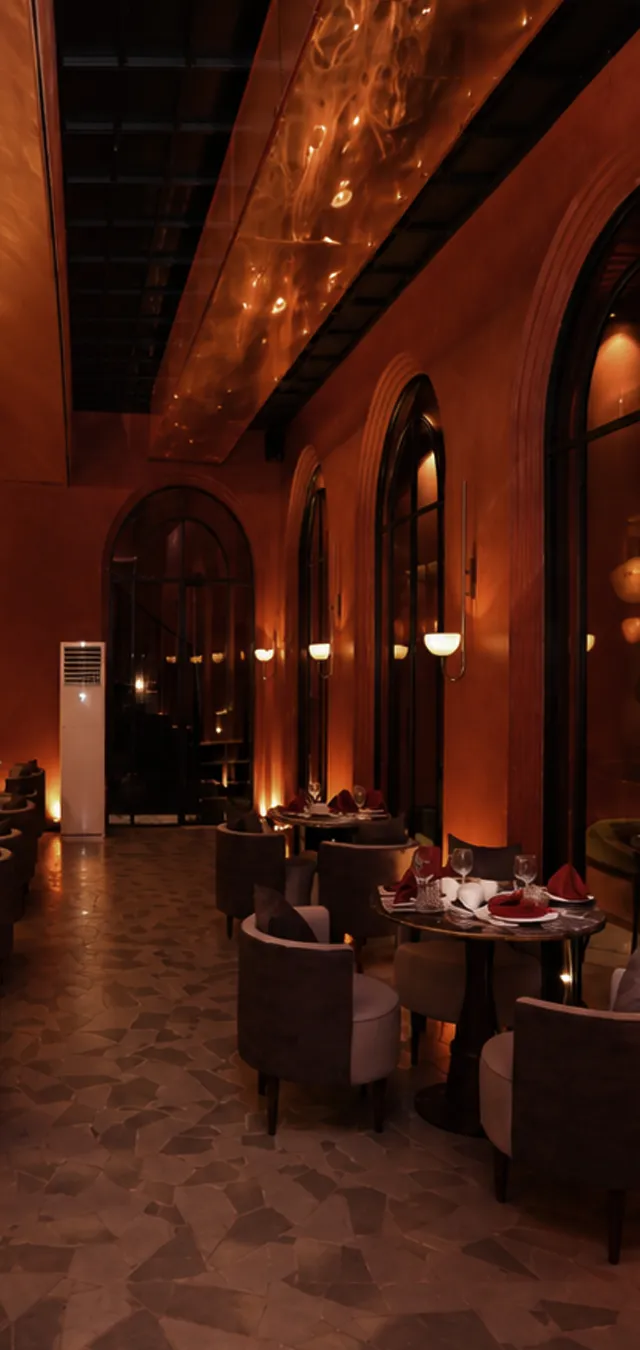 Long dining room with arched windows and glass pendant lamps