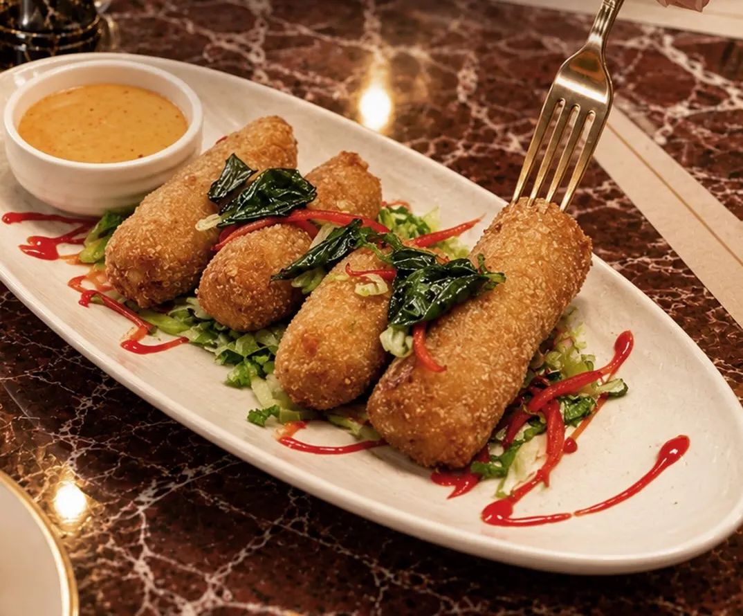 Chicken cordon strips on greens with dipping sauce