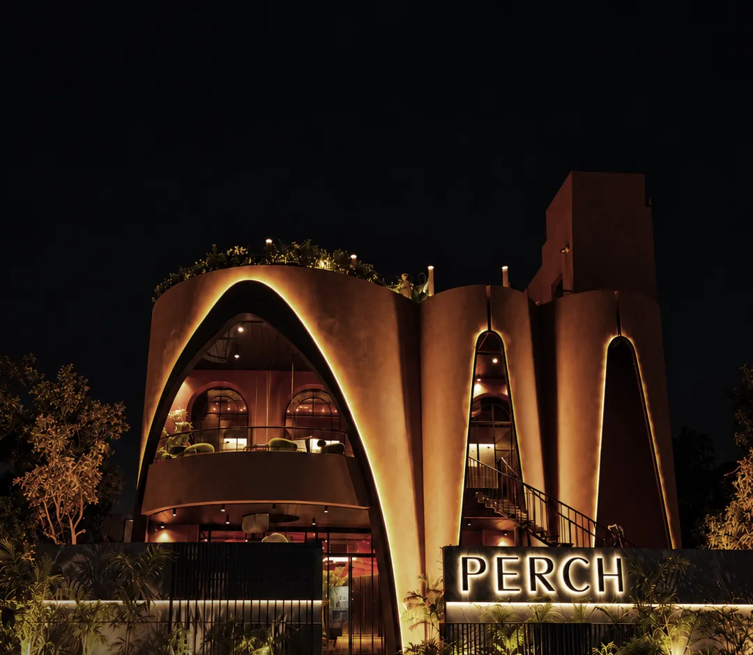 Perch's curved arched facade glowing at night with its illuminated sign