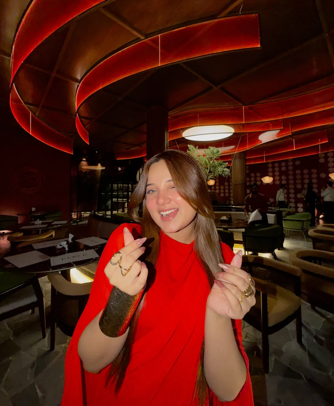 Guest in red under the ribbon ceiling