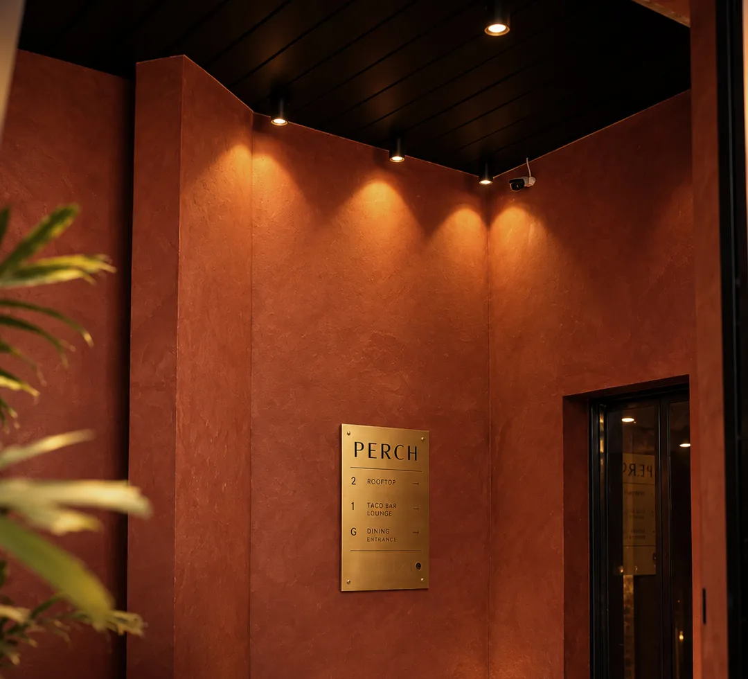 Terracotta lift lobby with Perch's brass floor directory