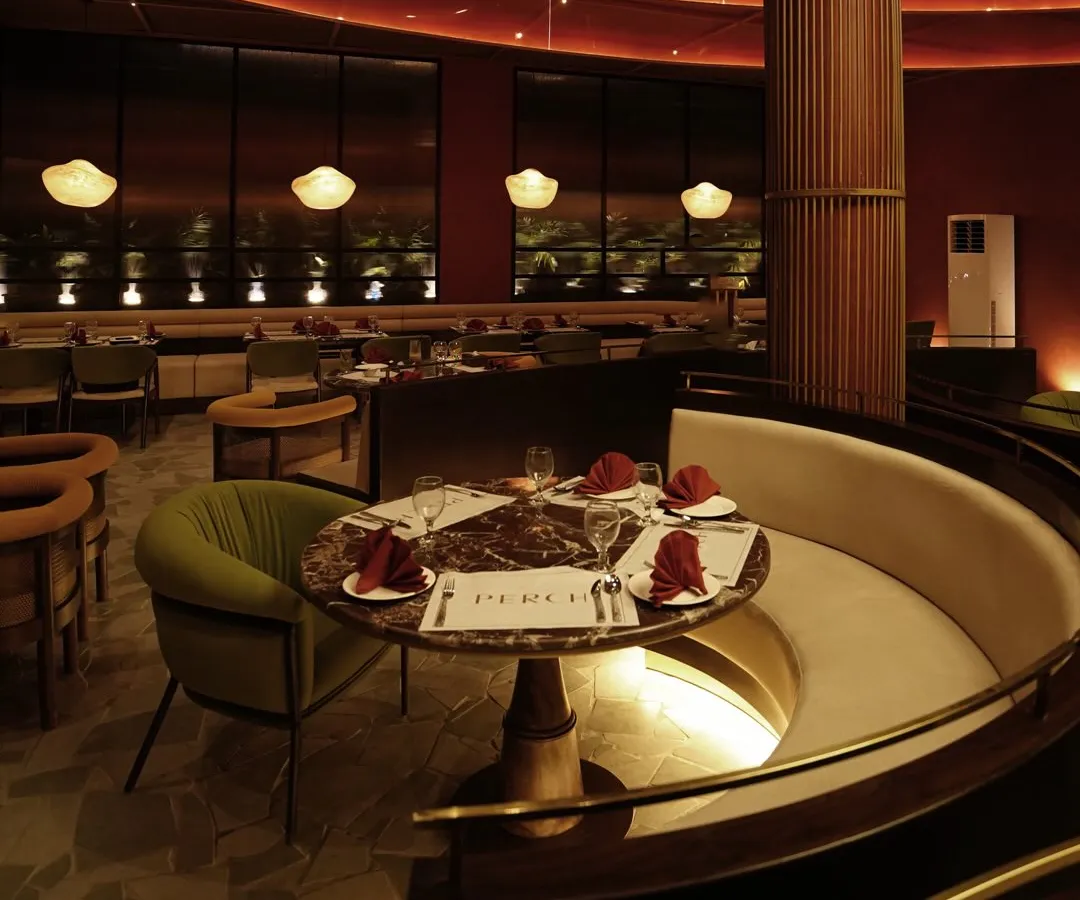 Curved booth beneath glowing red ribbon ceiling