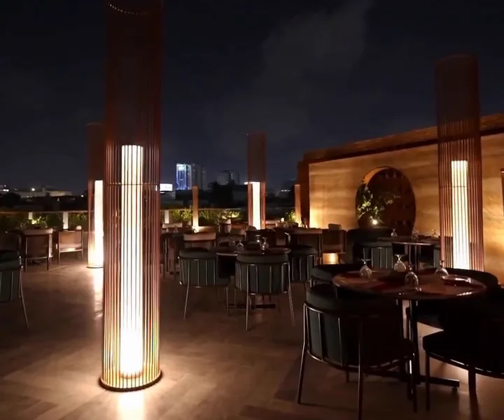 Rooftop terrace at night with glowing lantern columns